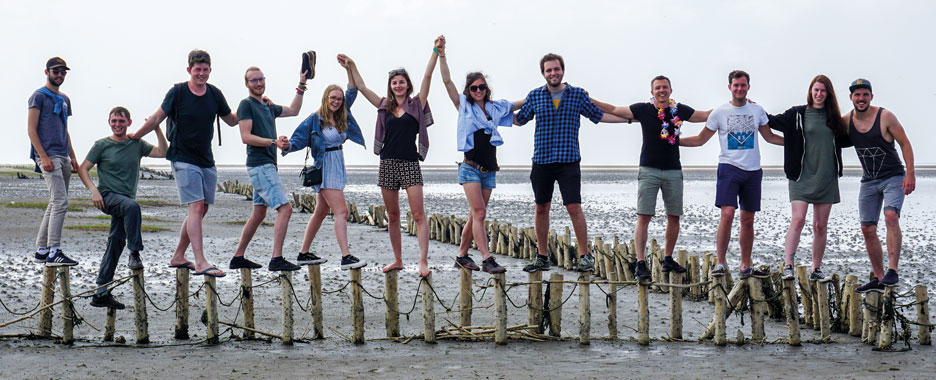 A group of students holding hands during their excursion to the Danish Wadden Sea Islands 