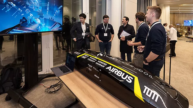 Three students present the TUM Hyperloop Pod