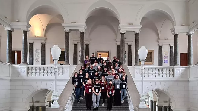 Group photo with the 22 ETA Fellows and the organizing team in the auditorium of PoliMi