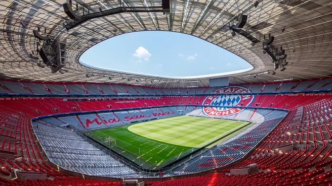 Inside view of the Allianz Arena with FC Bayern logo and Mia san mia lettering across the seats