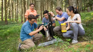 TUM PREP students with their supervisor during research work in the forest