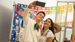 Two Mexican exchange students take selfies at TUM International Day on main campus.