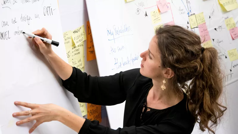 Woman writing notes on a flipchart