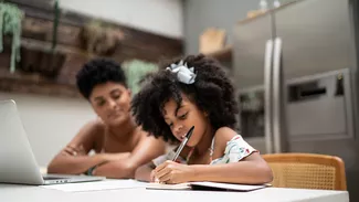 Little girl doing homeschooling with her mother