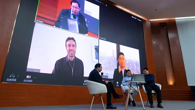 Presenters in the lecture hall of Tsinghua University with their guests connected via video call