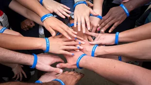 Hands of participants with different skin colors with TUM PREP bracelets