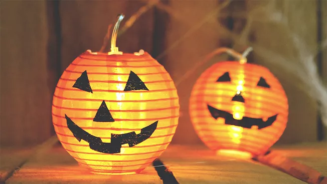 Two grinning pumpkin paper lanterns