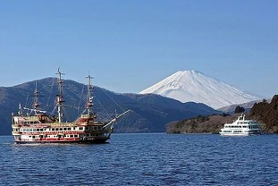 The snow-capped Mount Fiji photographed from the shores of a lake