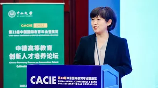 Zhenshan Jin at the speaker's desk