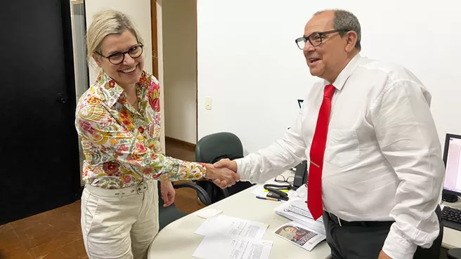 The two representatives of the partner universities in the office of the Director of International Relations at UFRJ