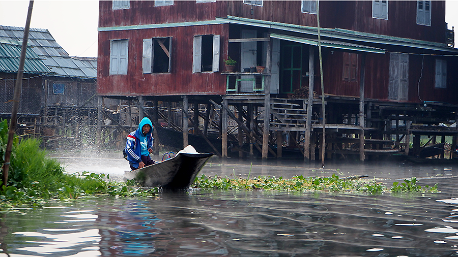 Local commuting on his way to work by boat