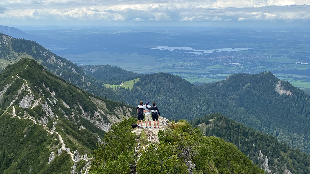 Three students enjoy the view of the Staffelsee from the Herzogstand together