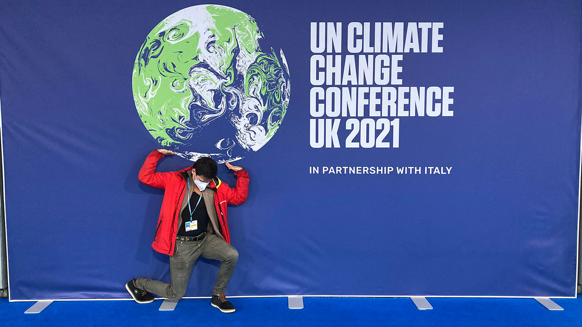 Man symbolically lifts globe