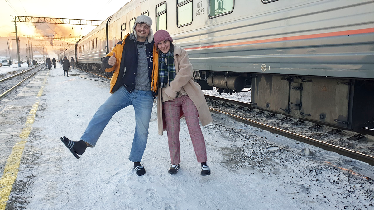 Two TUM students during a stopover of their train in wintry landscape