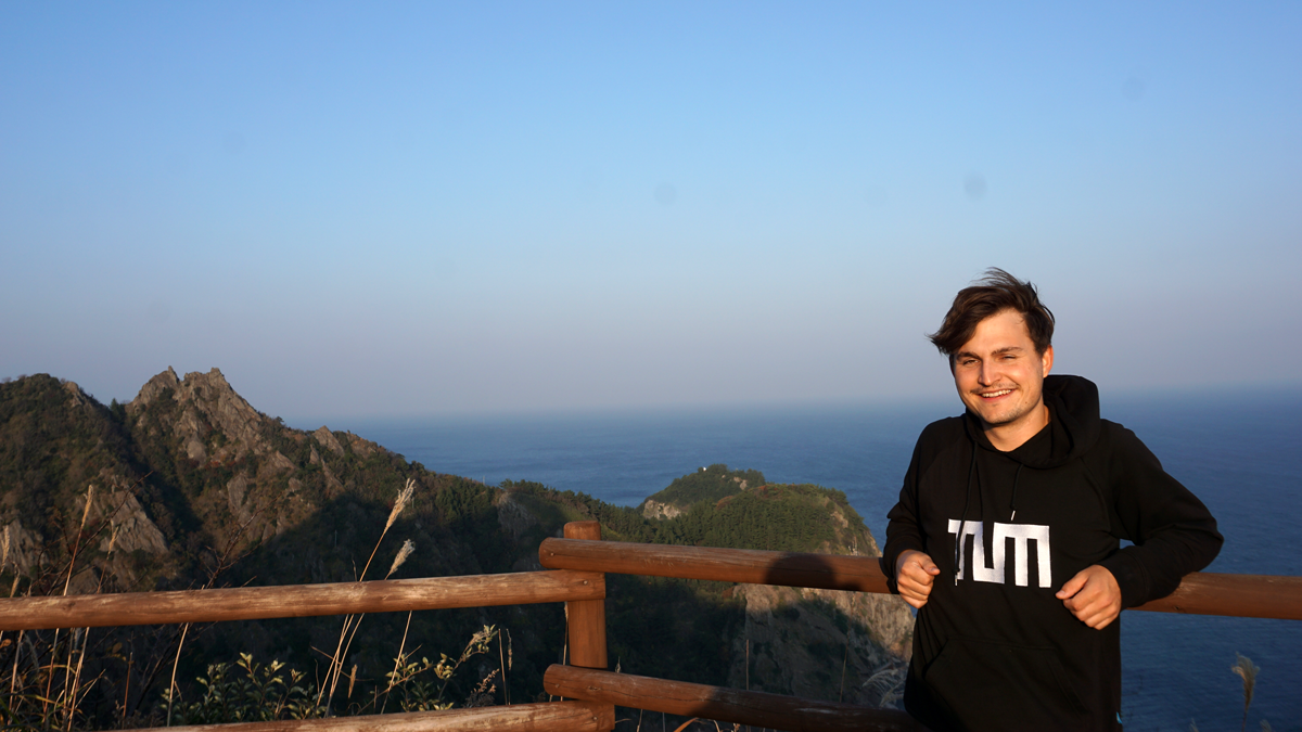 Young man with sea in the background