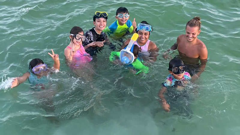Christopher Chvalina with colleagues and kids in the sea