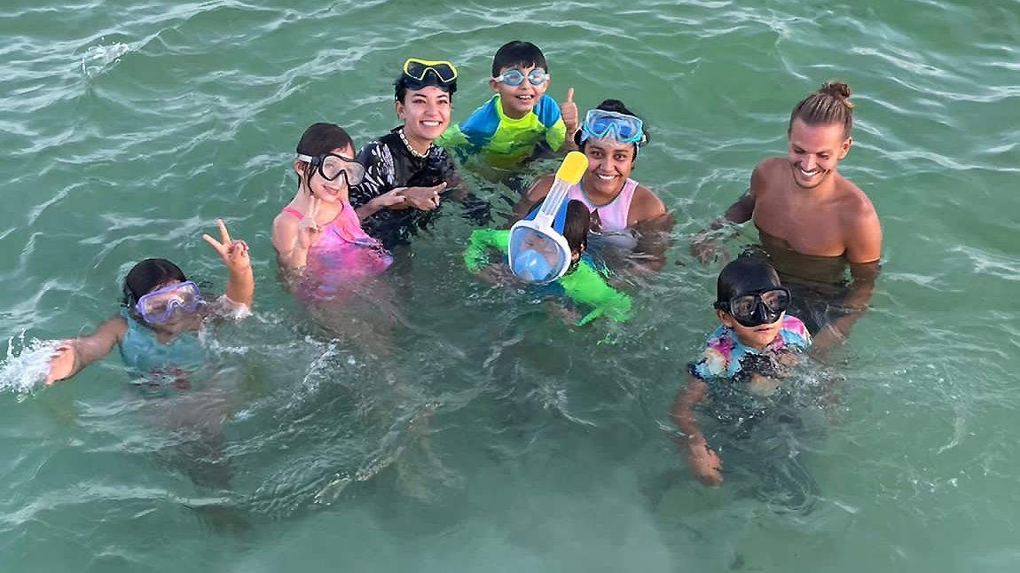 Christopher Chvalina with colleagues and kids in the sea