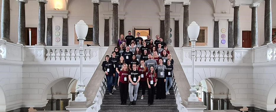 Group photo with the 22 ETA Fellows and the organizing team in the auditorium of PoliMi